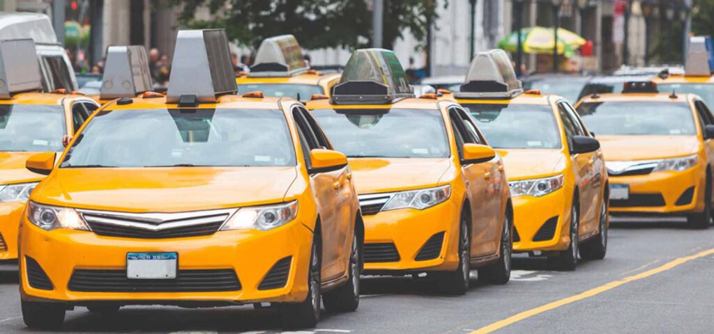 Many yellow taxis lined up on the street in Melbourne, representing the efficient and reliable Melbourne cab service.