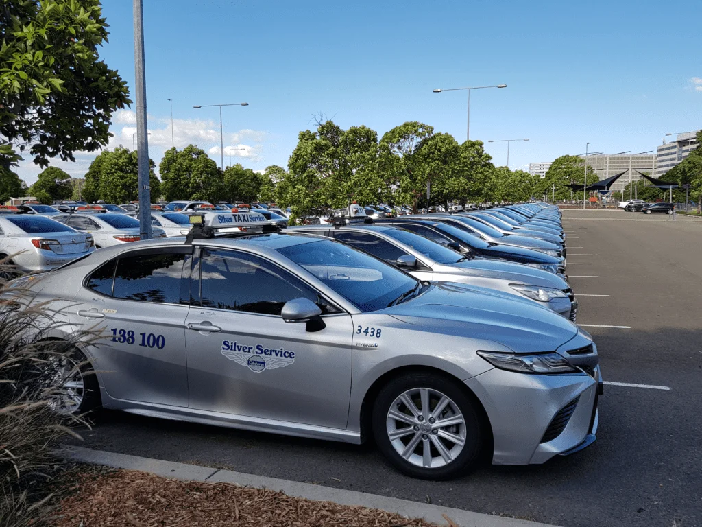 A line of parked cars in a lot.
